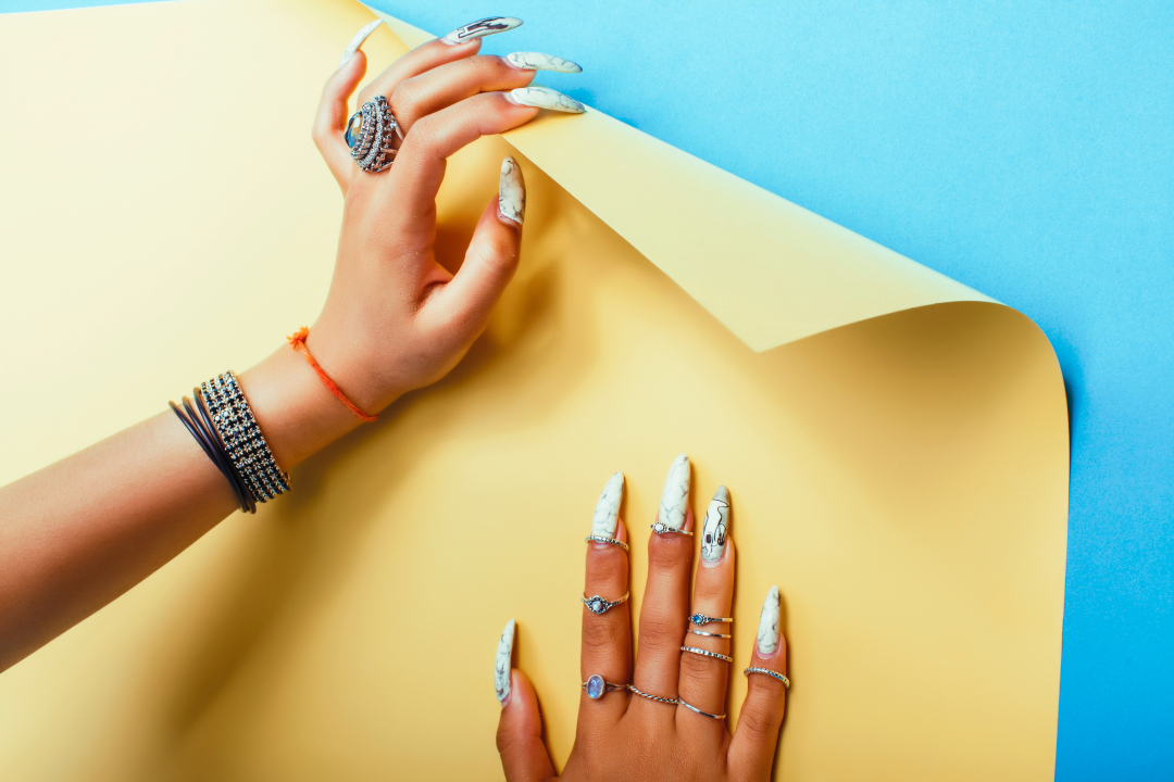 hands with jewelry and nail art on paper 2026 03 26 06 25 50 utc