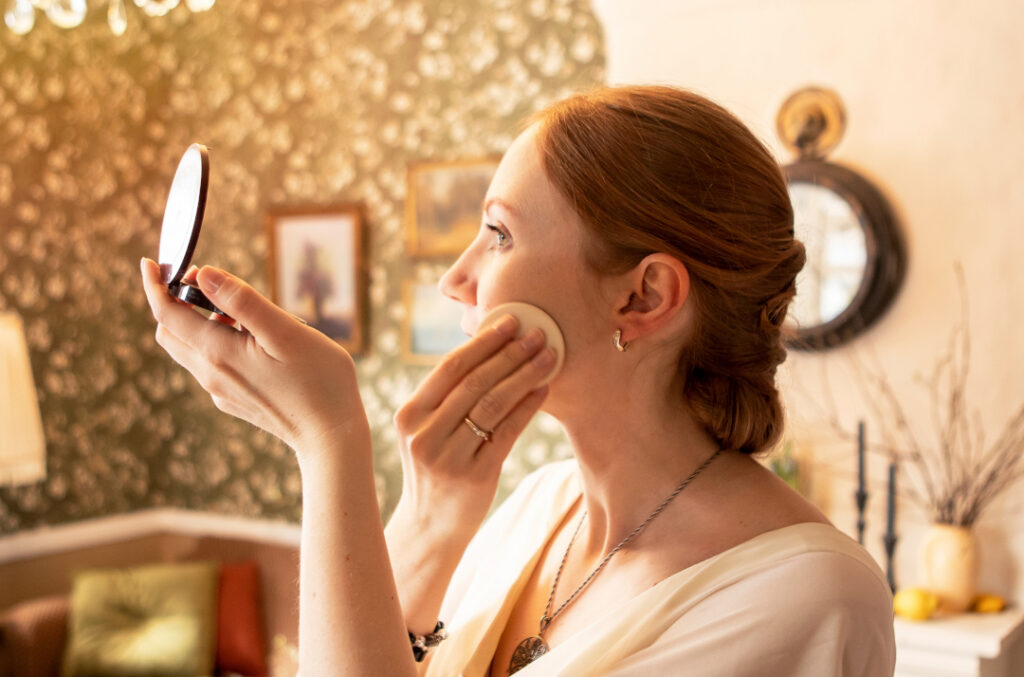 woman applying makeup in an indoor setting 2026 03 13 01 47 42 utc
